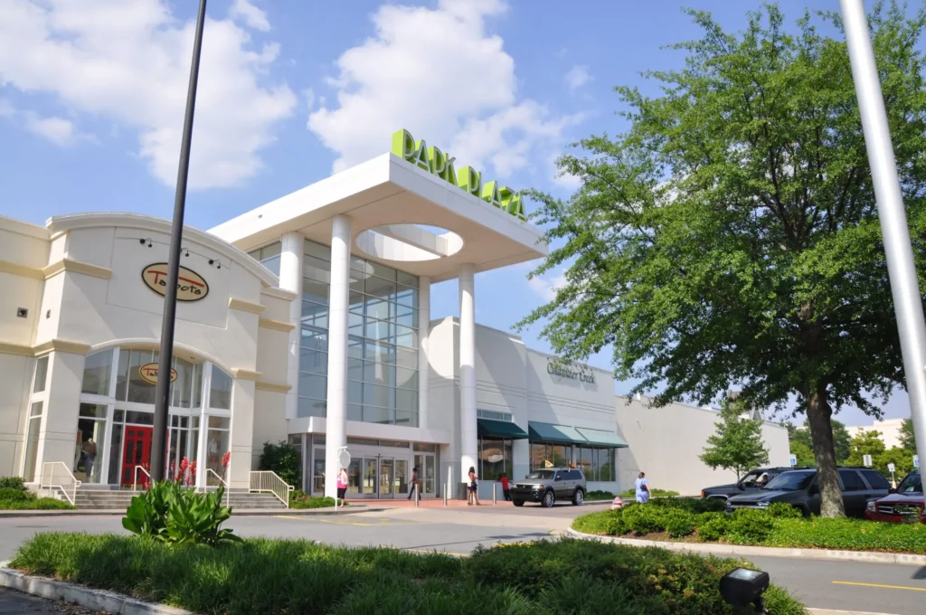 A large white building with a sign displaying 'Park Plaza Mall'.