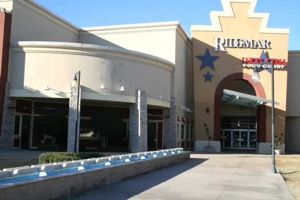 A large building with a fountain in front of it at Ridgmar Mall.