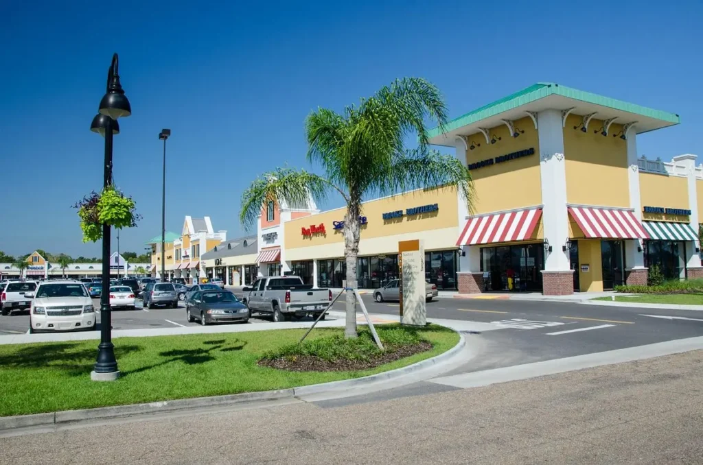 A view of Tanger Gonzales Mall, with cars parked in front