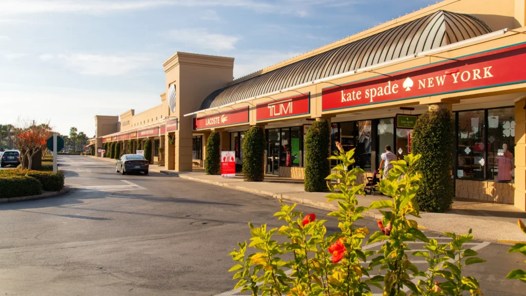 A store front with a red and white sign at Silver Sands Premium Outlets.