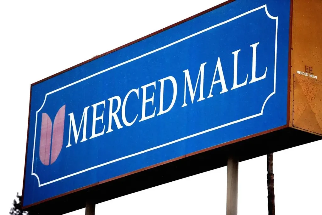 Blue and white sign reading "Merced Mall"