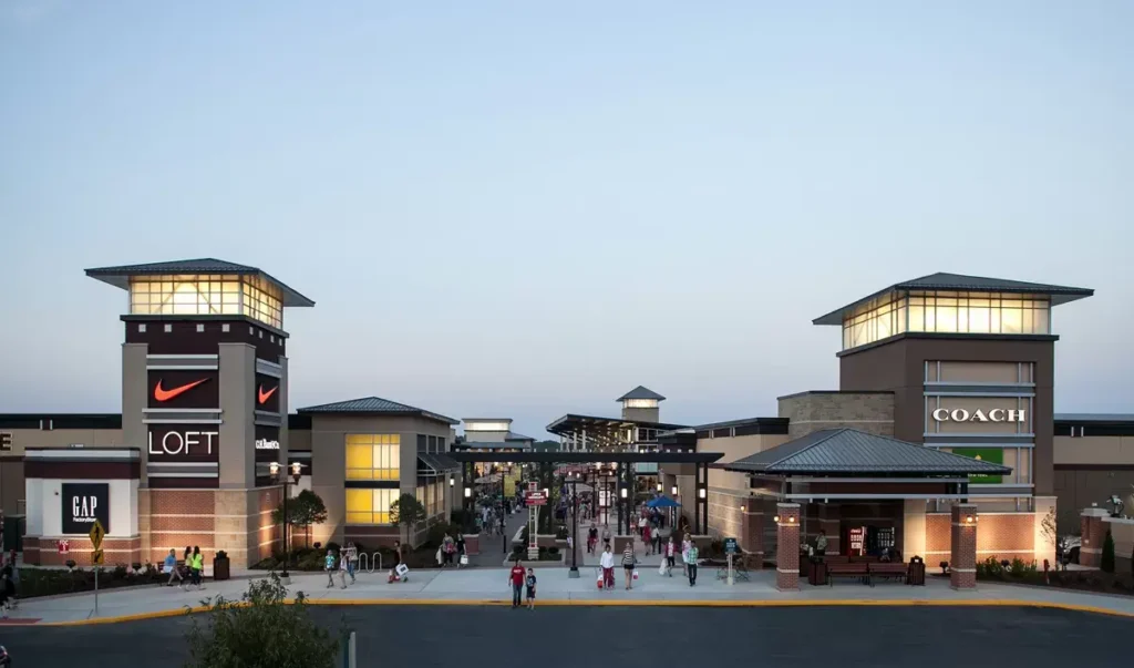 A vibrant scene at St. Louis Premium Outlets Mall during dusk