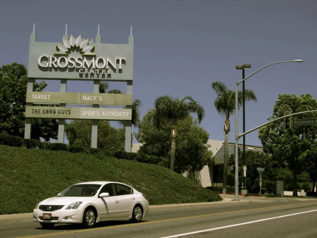 A car passing by a sign for Crosspointe Shopping Center