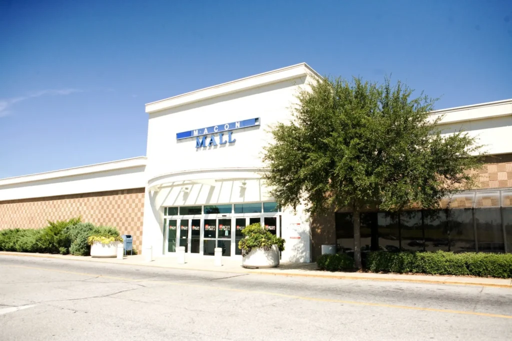 White building with blue 'Macon Mall' sign.