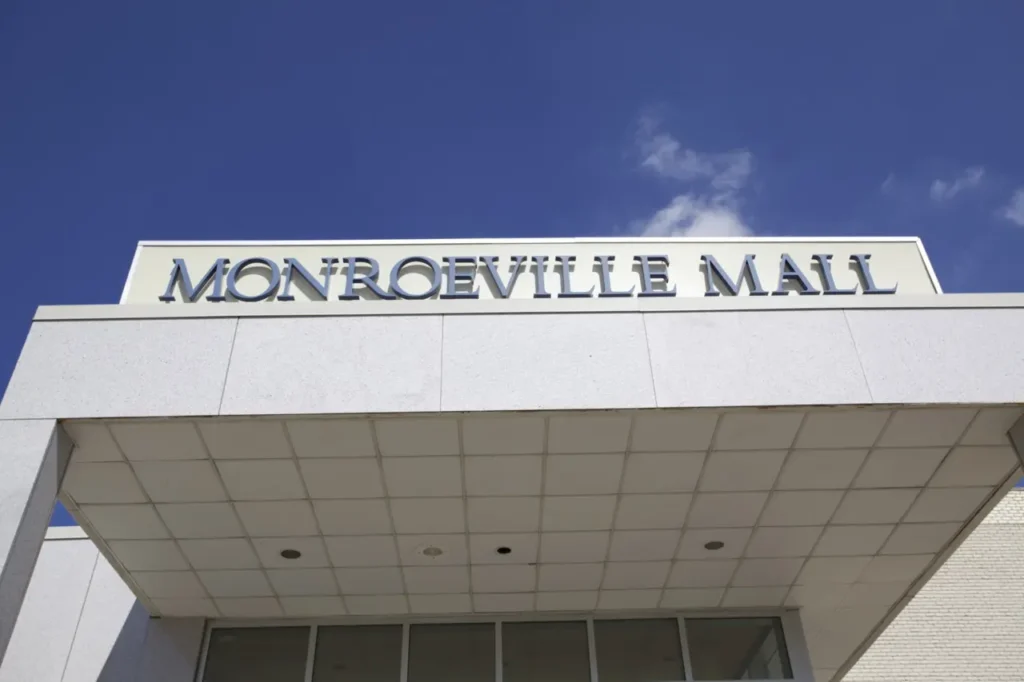 A white building with a sign saying Montgomeryville Mall