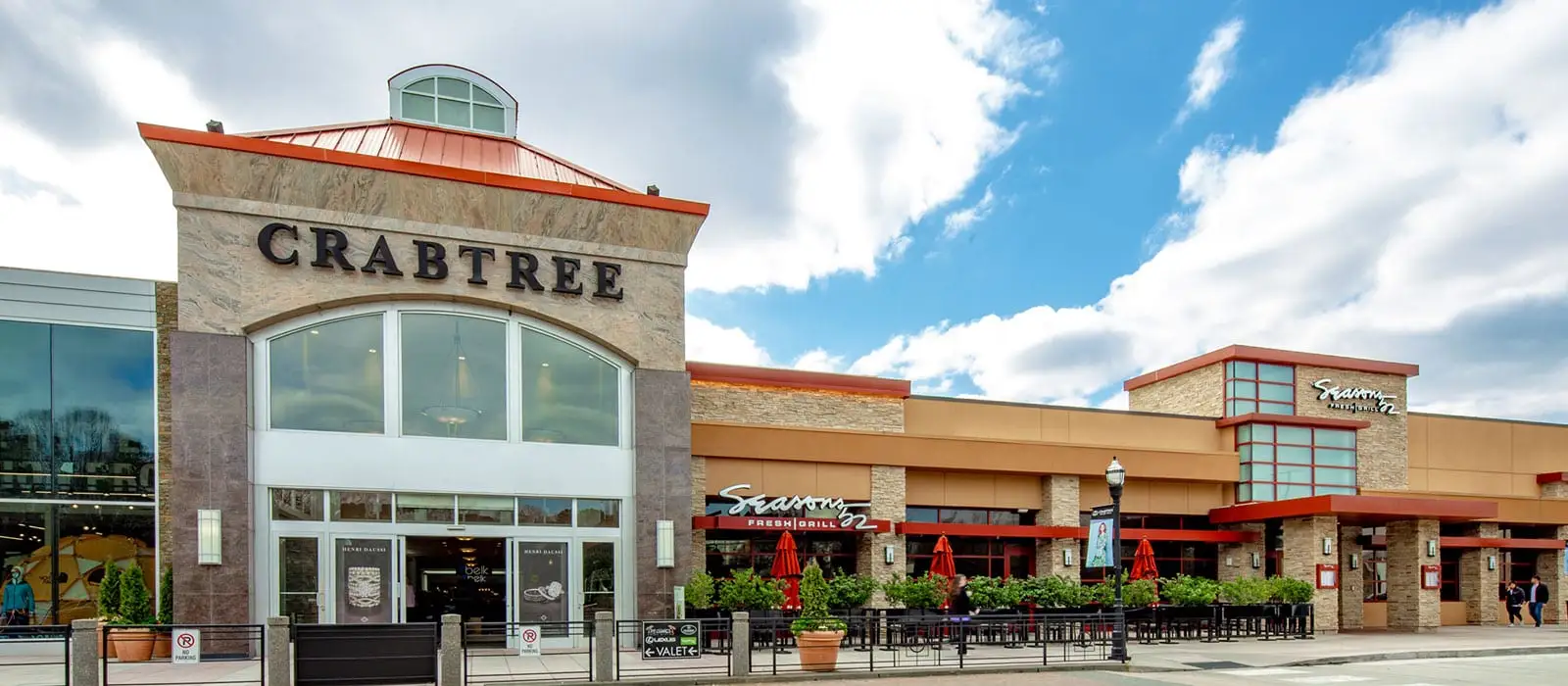 Discover a vibrant shopping center on a bustling street, where endless shopping opportunities await. Embrace the excitement of this lively mall!